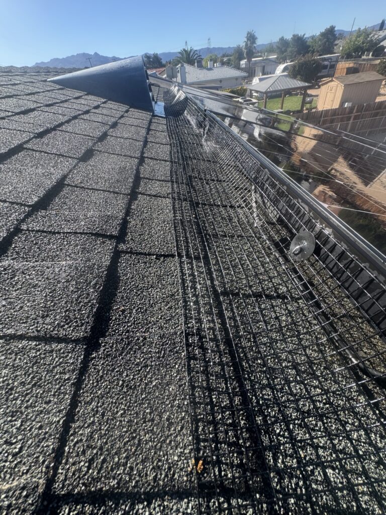 Bird proofing mesh fitted beside solar panels on a shingle roof